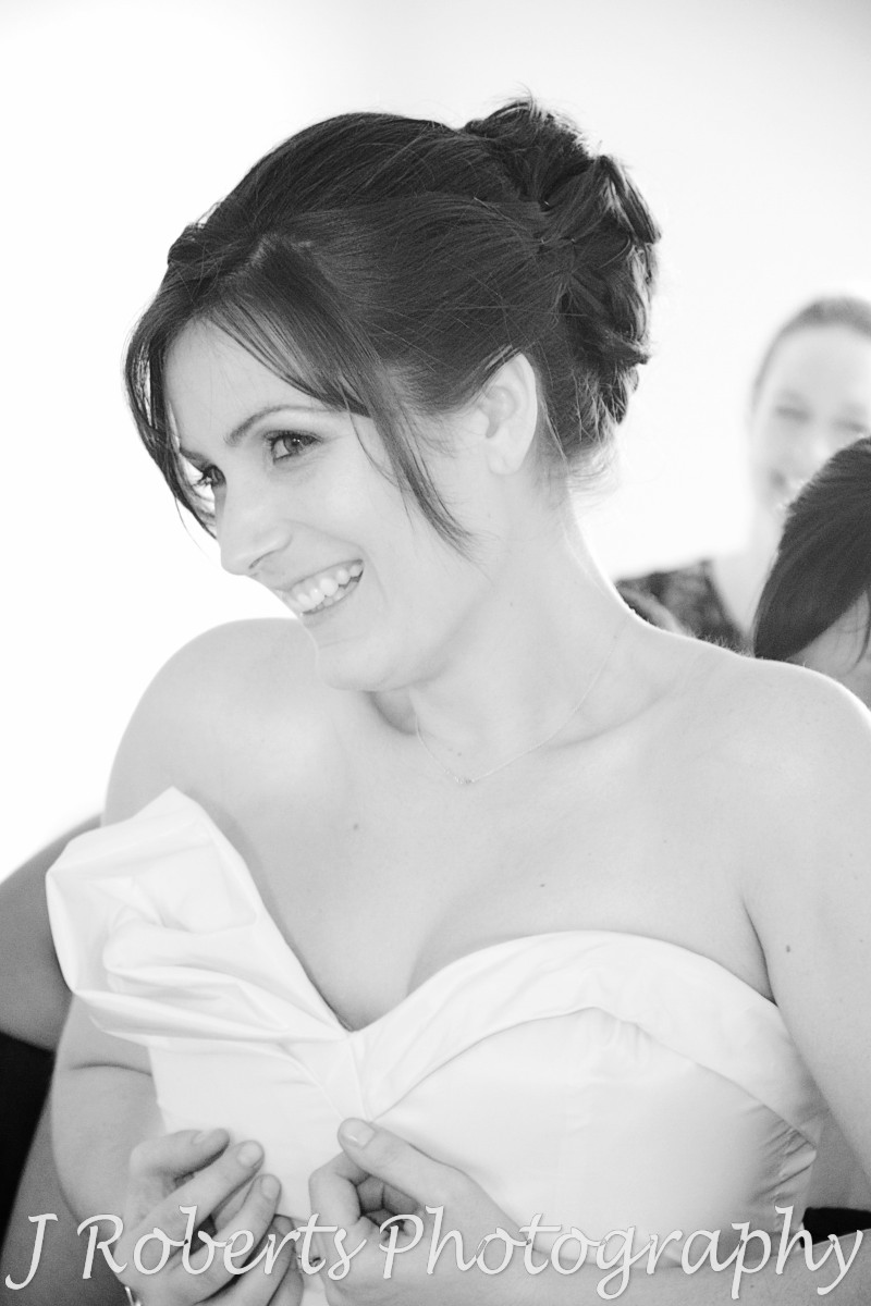 Bride having her dress zipped up - wedding photography sydney